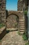 Arched gateway in stone wall with staircase
