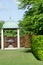 Arched Gazebo with Sculpture in English Garden