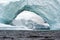 Arched iceberg in the frigid waters of Antarctica