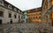 Arched inner courtyard of a Landhaus with a bronze fountain at sunset. Graz, Austria