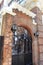 Arched iron gate and red brick wall