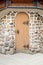 Arched medieval wooden door in a stone wall