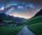 Arched Milky Way over the rural mountain road in summer in Italy