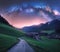 Arched Milky Way over the rural mountain road in summer in Italy