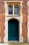 Arched rustic wooden door in a stone wall at Hampton Court Palace