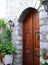 Arched stone entry with arched wooden door