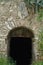 Arched stone gate of dark abandoned cellar