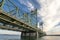 Arched truss lift bridge over the Columbia River against the backdrop of an evening cloudy sky connects Oregon and Washington