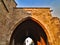 Arched tunnel gate with lamps.