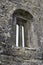 Arched window in medieval stone wall