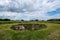 archeological pit cave in the ground in meadow