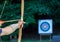 Archer aiming arrow at sport aim