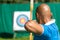 Archer aiming at target with bow and arrow