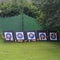 Archery targets outdoors with large green marquee