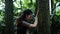Archery women sit in the jungle without fear