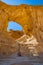 The Arches, amazing round hole in the rock, closed arch in ancient cooper mines canyons and mountains range in Timna National Park