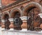 Arches in brick architectural detail with ornamental wrought iron grill work on street in Yaroslavl, Russia