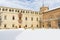 archiepiscopal palace of alcala de henares covered in snow on a sunny day after a snowfall
