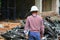 Architect-engineer businessman wear helmet in construction building site, back view