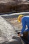 Architect Holding Blueprint While Using Measuring Tape At Constr