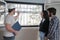 Architect shows the insect screen of the window of a new apartment to a couple.