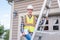 Architect standing on a ladder.