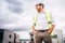 Architect supervising workers on construction site.Dramatic portrait of man on construction of building site