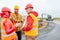 Architect and two construction workers discuss road construction