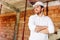 architect visiting the construction site. Portrait of construction worker with brick walls