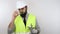 Architect wearing safety helmet and reflective jacket removing gloves and safety glasses, doing thumb up sign