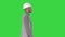 Architect in white helmet walking on a Green Screen, Chroma Key.