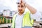 architect working on construction site, wearing hard hat and safety vest