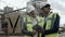 Architects standing on construction site and using tablet