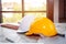 Architects and workers` safety helmets are placed on the construction site of the building.