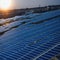 Architectural Detail of Metal Roofing on Commercial Construction Solar panels or Solar cells Over Factory, Blue Sky With Sun Rays