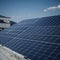 Architectural Detail of Metal Roofing on Commercial Construction Solar panels or Solar cells Over Factory, Blue Sky With Sun Rays