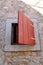 Architectural detail: small rustic window on a traditional Mediterranean house. Vertical format, natural light.