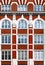 Architectural detail of Victorian building, with red brick, arched windows and decorative plaster work in Art Nouveau style