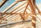 Architectural details of attic, wooden roof system at construction site
