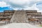 Architectural details of the walls of  significant Mesoamerican pyramids and green grassland located at at Teotihuacan, an ancient