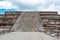 Architectural details of the walls of  significant Mesoamerican pyramids and green grassland located at at Teotihuacan, an ancient