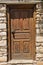 Architectural details of a weathered doors on an old stone house in a narrow winding streets at the old town of Skiathos