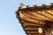 Architectural details of wooden eaves and ceramic tile roof ends of tradition house at Korean ancient village in South Korea
