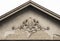 An architectural ornament relief  on the front house facade, vintage roof peak decoration