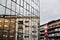 Architecture buildings background with new glass facade, old blocks and reflection