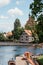 Architecture of Bydgoszcz. Houses and churches of the city in Poland. Pier with catamarans and kayaks. House over the river.