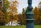 architecture detail autumn park metal streetlight trees lake sky yellow leaves nature