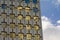 Architecture detail, windows with rounded corners of an office building and blue sky with clouds