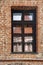 Architecture details. Beautiful window in the brick palace castle. The reflection in the glass of the sky and buildings