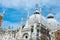 The architecture of the Doge`s Palace from the courtyard: the clock, sculptures and domes, Venice, Italy